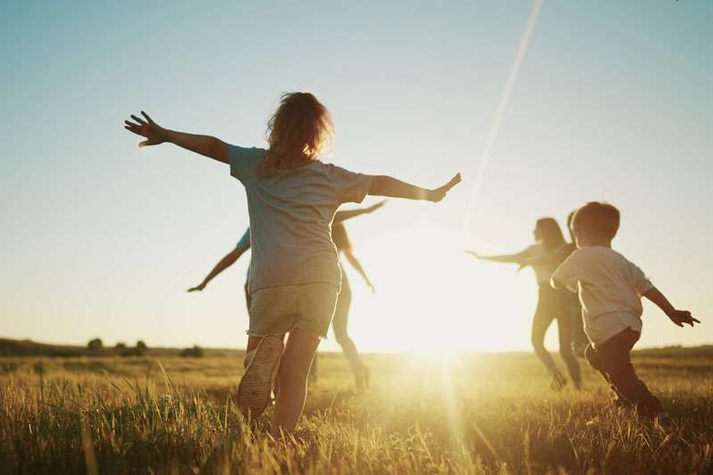 kids-playing-in-field-colin-austin-gbiota