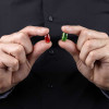 hands-holding-red-and-green-capsules-colin-austin-gbiota