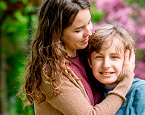 woman-holding-boy-colin-austin-gbiota
