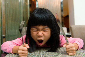 angry-child-holding-utensils-colin-austin-gbiota