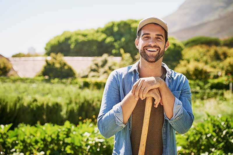 man-smiling-while-gardening-colin-austin-gbiota