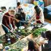women-around-table-with-green-plants-colin-austin-gbiota